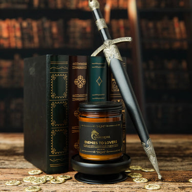 Medium Enemies To Lovers scented candle with books and a dagger